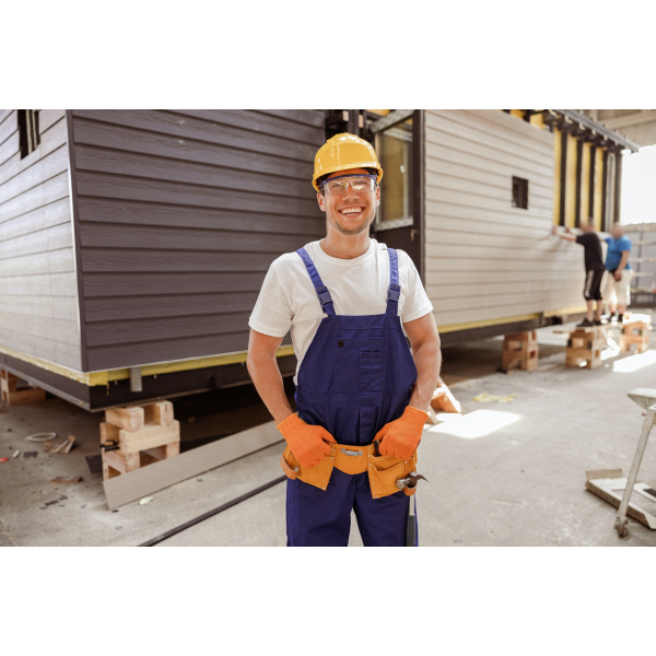 Cheerful male builder standing at construction site